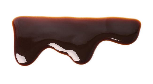 Flowing chocolate sauce on white background