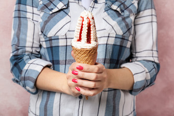 Woman holding yummy ice cream, closeup. Focus on hands