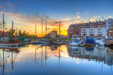 Fototapeta na wymiar Beautiful marina with yachts in Gdansk reflected in the river at sunrise, Poland.