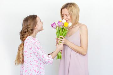 Fototapeta na wymiar Daughter give mom flowers