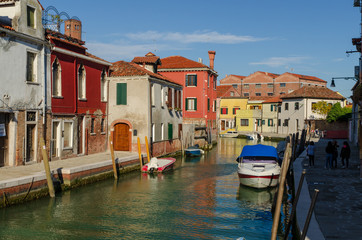 Fototapeta na wymiar Venetian canal with boats docked on the Murano island
