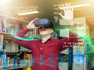 Smart young man in a library travels in a virtual futuristic world with augmented reality. Concept:...