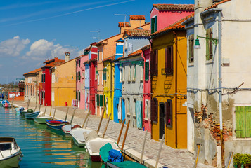 Fototapeta na wymiar Colorful houses and boats docked at Burano near Venice.