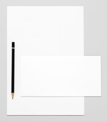 Blank stationery: paper, envelope, and pencil 