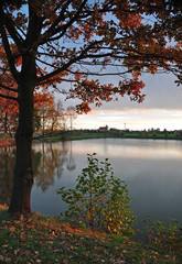 Autumn afternoon at a pond with a church in the background.
