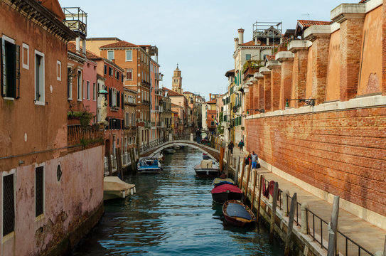 View of a canal Rio de la Sensa in Venice with some boats and a sunny light, Italy