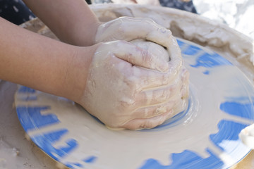.the child learns pottery.