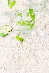 Summer fresh iced drink, mint and cucumber infused water, summer healthy detox mojito cocktail, light background copy space