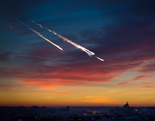 Fototapeta na wymiar Falling meteorite, asteroid, comet on night city. Elements of this image furnished by NASA.