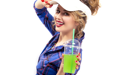 Youth Ideas.Closeup of Enticing Caucasian Female in Checked Shirt Offering Green Cocktail Towards Viewer. Against White Background