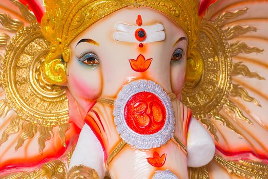 Close up of God Ganesh colorful image with the Om symbol on the face.