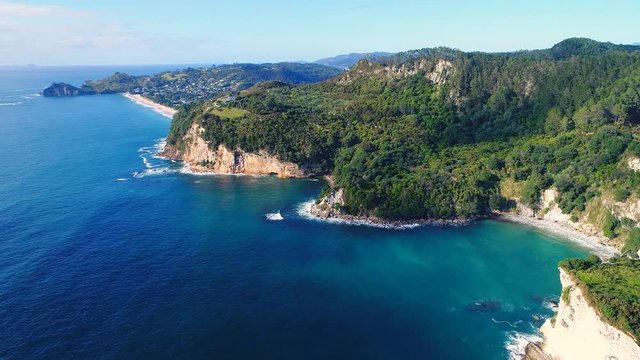 Aerial view of white cliffs and beaches of Cathedral Cove - South Pacific Ocean shore, Coromandel Peninsula, North Island, New Zealand from above, 4k UHD