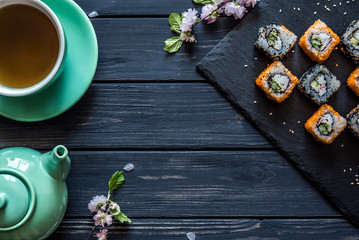 Obraz na płótnie Canvas Sushi and tea in a kettle