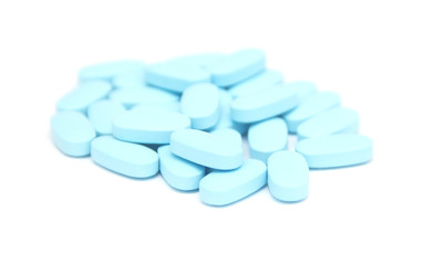 blue pills, capsules, tablets on white