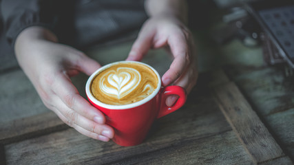 Hand Holding Hot Latte Coffee