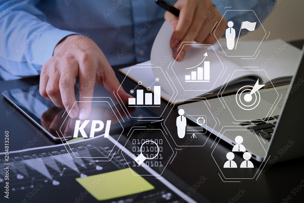 Poster close up of businessman working with smart phone and digital tablet and laptop computer on wooden de