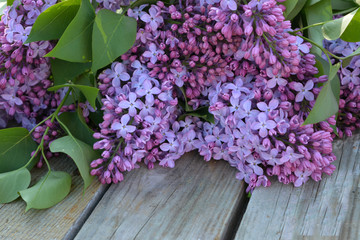 bouquet of flowers in purple lilacs on a wooden background