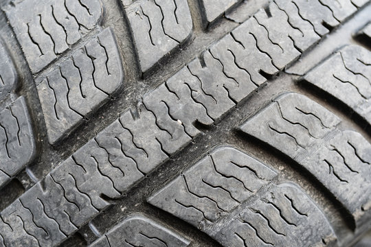 Closeup on worn out tire tread as a background.