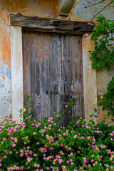 Weathered door of a house, ruined by the 1953 earthquake, in Assos on the island Kefalonia in Greece 