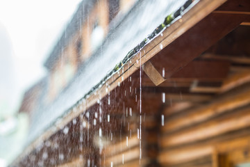 Downpour in the summer storm and rain drops on the roof