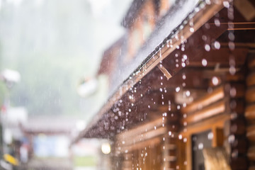 Downpour in the summer storm and rain drops on the roof