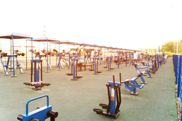 Outdoors gym. Blurred picture of exercising people. Workout space