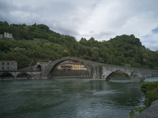 Stone arch bridge from the 14th century over the river Serchio Ponte della Maddalena