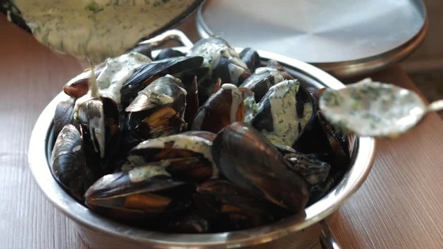 cook sea shellfish. mussels with garlic sauce. sea food
