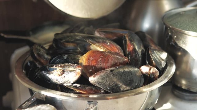 cook sea shellfish. mussels with garlic sauce. sea food