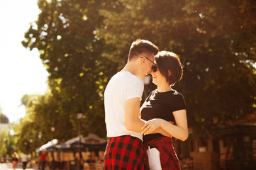 Couple loving each other outdoors at sunset on city street, Engaged couple