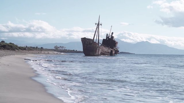 Greek coastline with the famous rusty shipwreck in Glyfada beach near Gytheio, Gythio Laconia Peloponnese Greece 4K