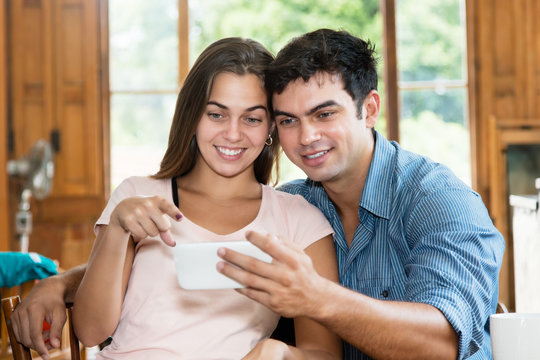 Love couple watching tv on cellphone