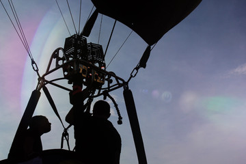 Silhouette people and floating balloons. © Siriporn