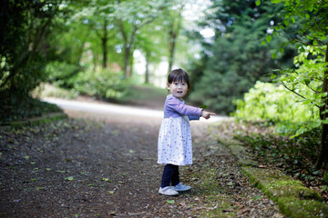 baby girl play at spring forest garden