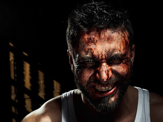 A strong, a serious, muscular man in a white t-shirt is worth and looks in camera. He's got the...