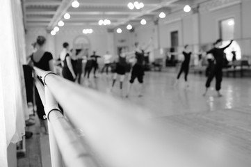 The ballet troupe rehearses in a ballet class against the backdrop of a ballet or barre