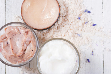 cosmetic creams and lavender on white wood table background