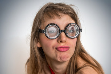 Fototapeta na wymiar Funny nerd or geek woman with sexual expression on face