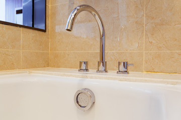 Tap and overflow button on bathroom