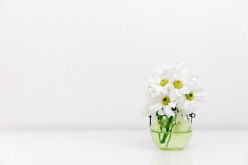 Spring flowers in vase. Minimalistic bright background