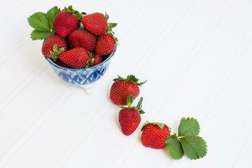 Freshly Picked Strawberries in Blue Bowl on White Tabletop