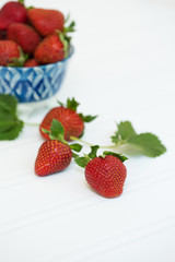 Freshly Picked Strawberries in Blue Bowl on White Tabletop