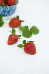 Freshly Picked Strawberries in Blue Bowl on White Tabletop