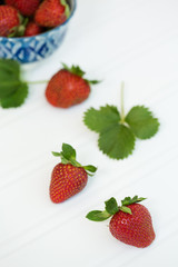 Freshly Picked Strawberries in Blue Bowl on White Tabletop
