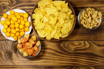 Mix of snacks for beer on wooden table