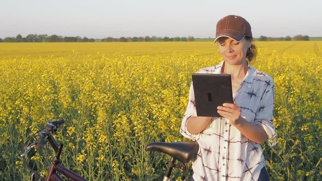 Cyclist with a tablet. Female farmer with tablet.