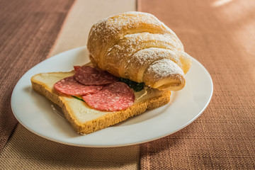 croissant dish on white ceramic plate in hotel cafe