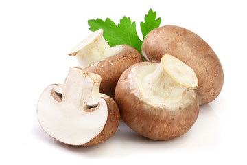 Royal Brown champignon with half and parsley leaf isolated on white background