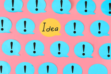 On a pink background many blue stickers with question marks are glued. One of the stickers is...