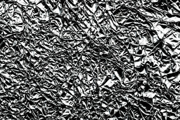 Monochrome pattern of crumpled silver aluminum foil background.